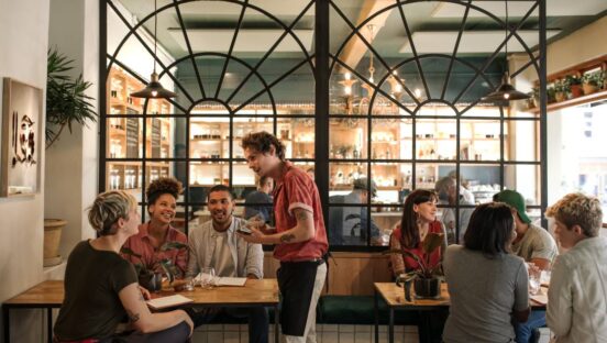 Adobe stock server taking an order in a restaurant.