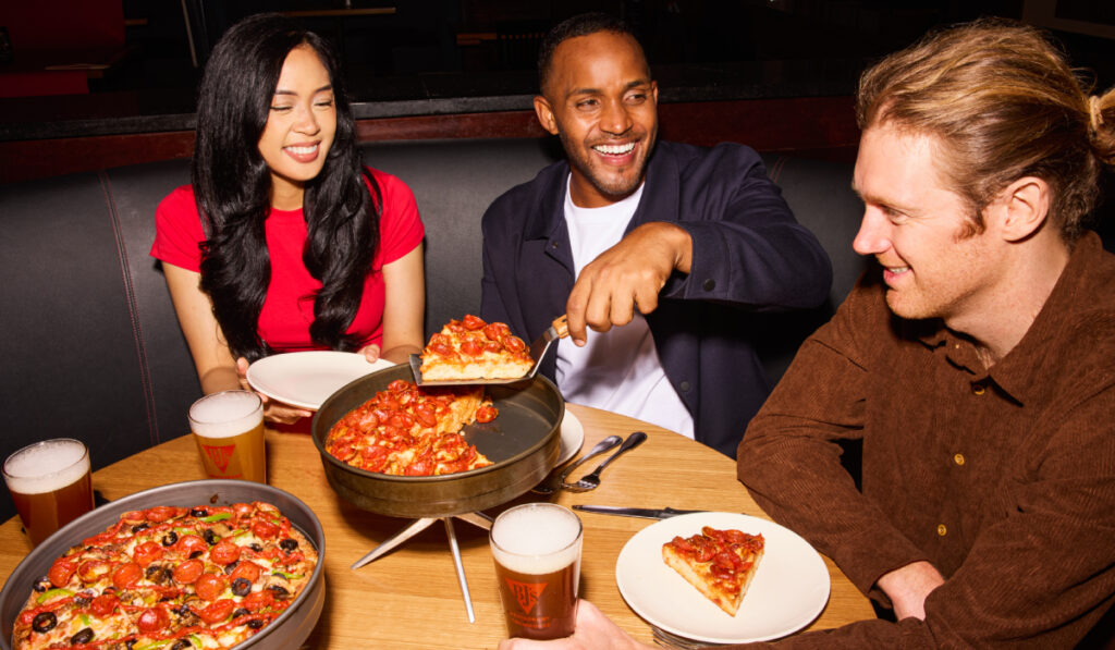 Customers enjoying pizza at BJ's.