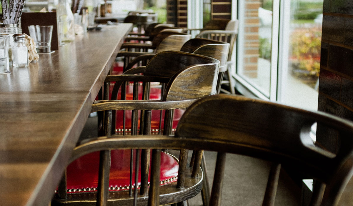 Chairs Against A Bar At An Empty Restaurant