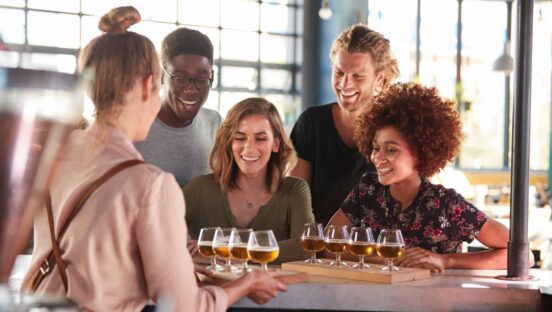 Friends beer tasting at a restaurant.