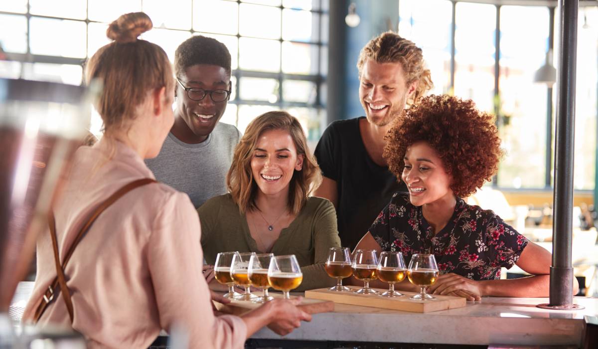 Friends beer tasting at a restaurant.