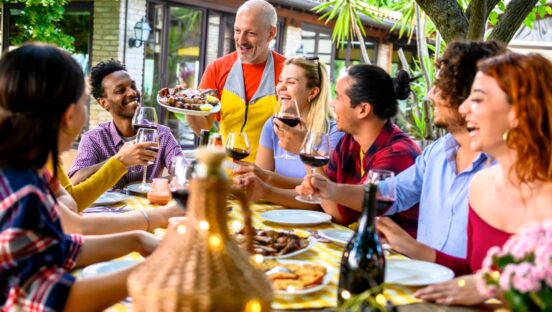 Group of friends dining at vibrant restaurant Adobe Stock.