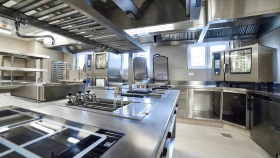 A stainless steel kitchen in a restaurant.