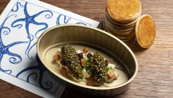 Petrossian Caviar Service with sherry-roasted banana puree topped with Petrossian caviar and a side stack of banana bilini.