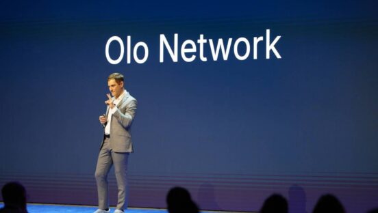 CEO Noah Glass on stage, explaining Olo Network.