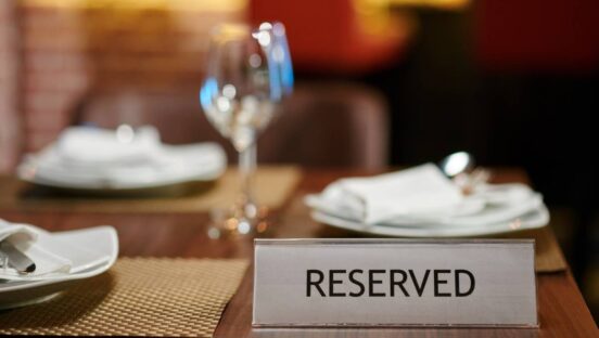Reserved sign on table in fancy restaurant.