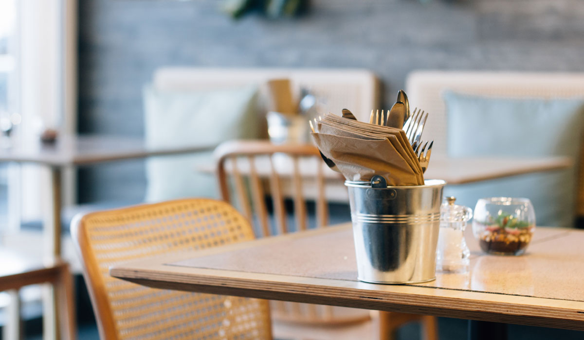 Gray Stainless Steel Cup With Tissue On Brown Table