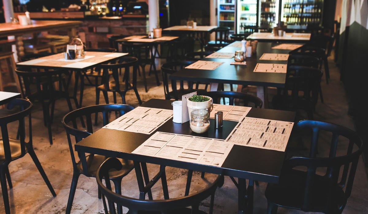 An Empty Restaurant With Tables And Chairs With Menus