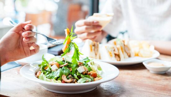Two people having a business meeting over lunch.