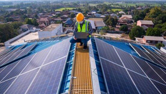 Technician checks the maintenance of the solar panels on the roof.