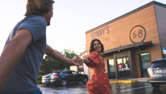 Sonny's BBQ concept exterior with a happy couple.