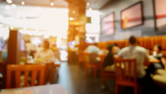 Blurred interior of a sit-down restaurant.
