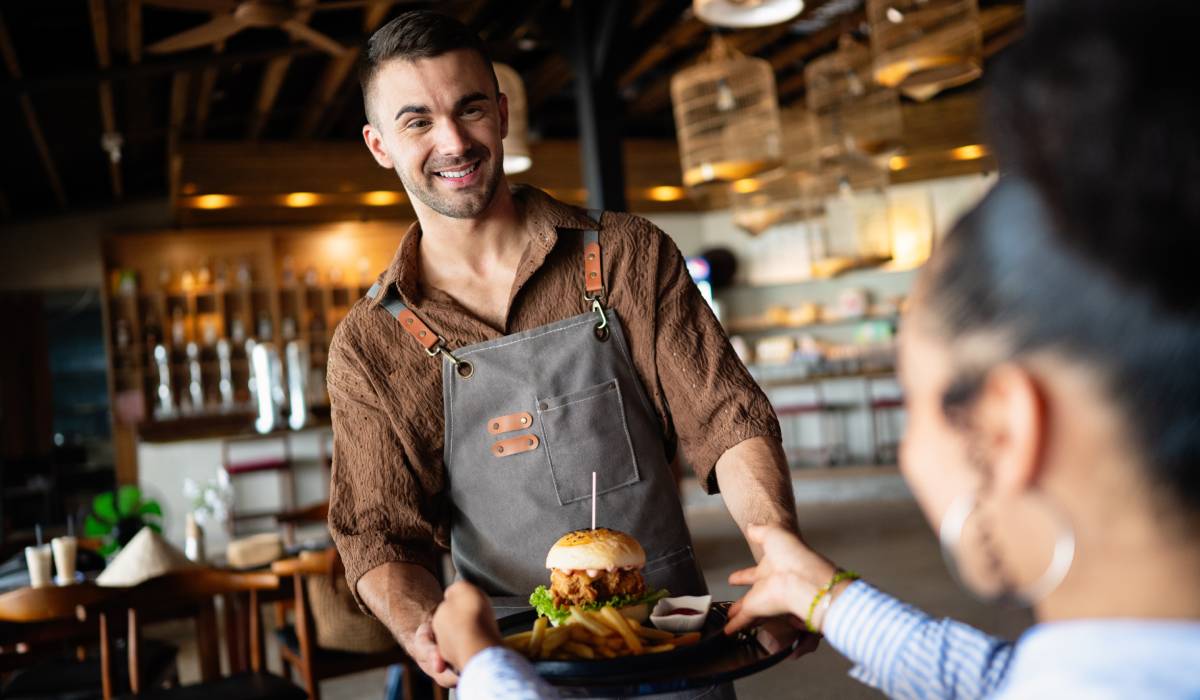 A waiter serving food.
